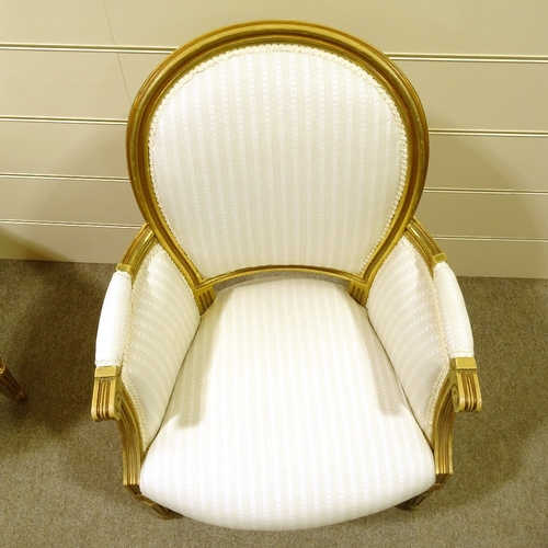 113 - A pair of French carved giltwood-framed salon armchairs, recently re-upholstered in pale striped fab... 