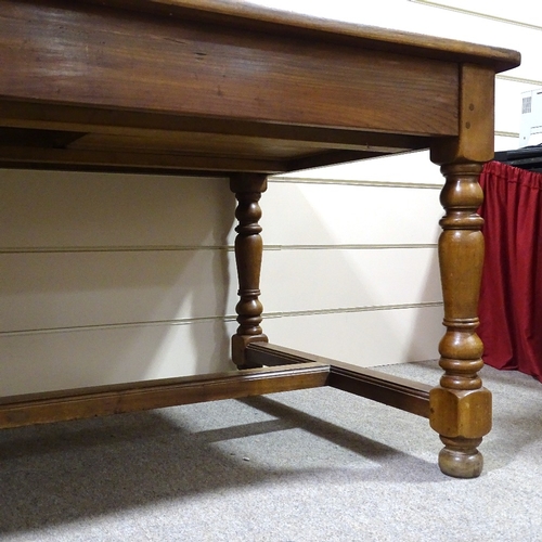 302 - A large cherrywood refectory style farmhouse table, 2cm thick plank-top, with turned supports, end f... 