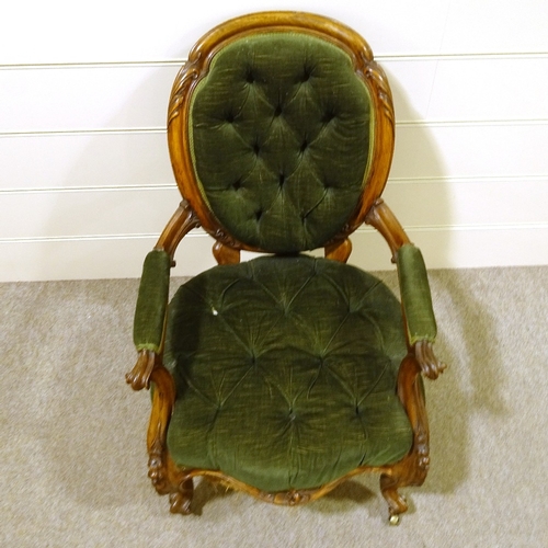 411 - A Victorian open arm fireside chair with carved and scrolled surround