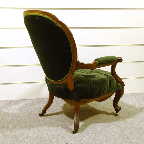 411 - A Victorian open arm fireside chair with carved and scrolled surround