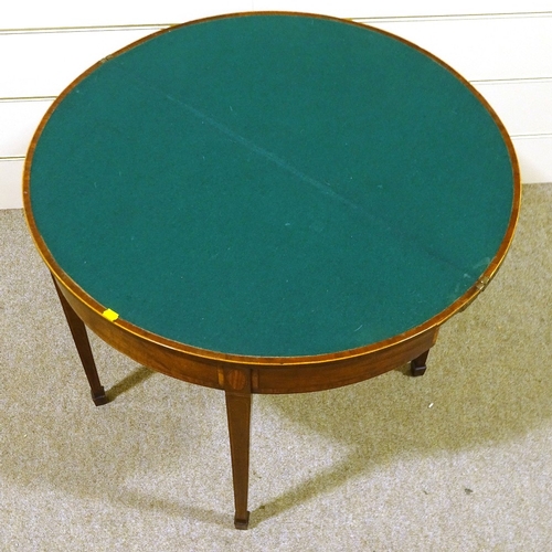 413 - A George III mahogany demilune fold over card table, with tapered legs and spade feet