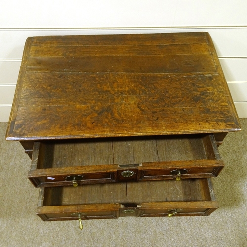 459 - A 17th century joined oak chest of 4 long graduated drawers, with panelled drawer fronts, brass drop... 