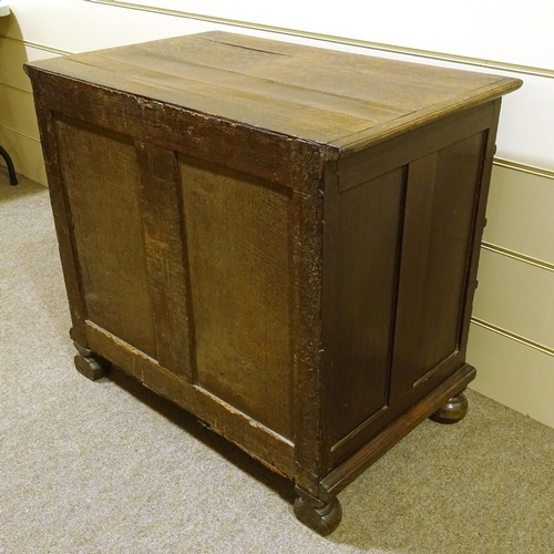 459 - A 17th century joined oak chest of 4 long graduated drawers, with panelled drawer fronts, brass drop... 