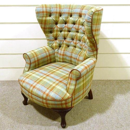 93 - A barrel-back wing armchair, recently re-upholstered in buttoned tartan fabric, with rollover arms a... 