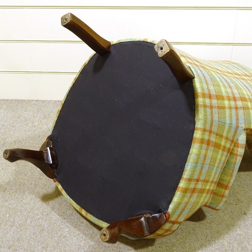 93 - A barrel-back wing armchair, recently re-upholstered in buttoned tartan fabric, with rollover arms a... 