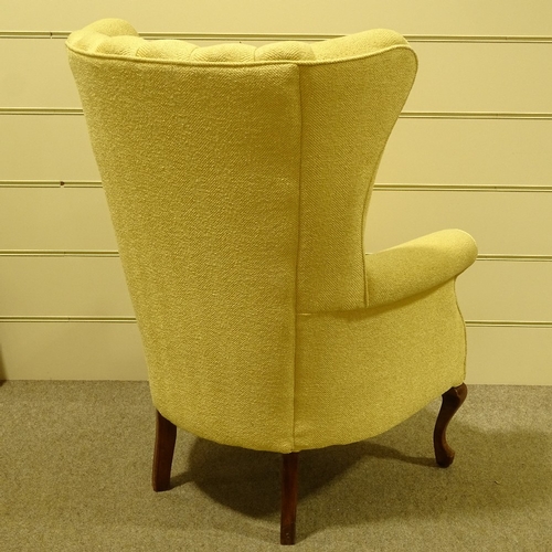 94 - An Art Deco upholstered wing armchair, circa 1930s, recently re-upholstered in pale gold fabric, on ... 