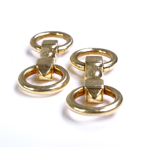 570 - CARTIER - a pair of 18ct gold snaffle horse bit pattern cufflinks, with articulated rings, both sign... 