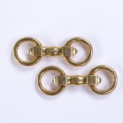 570 - CARTIER - a pair of 18ct gold snaffle horse bit pattern cufflinks, with articulated rings, both sign... 