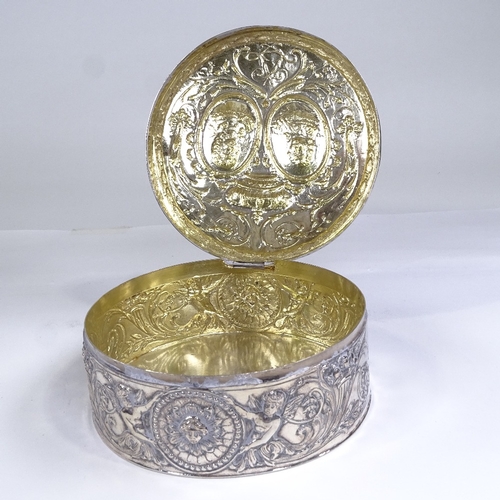 586 - An early 19th century Dutch silver circular box, hinged lid decorated with coronet and relief emboss... 