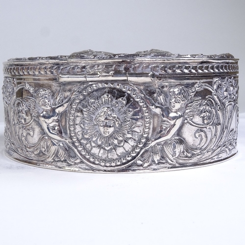 586 - An early 19th century Dutch silver circular box, hinged lid decorated with coronet and relief emboss... 