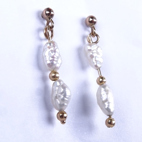 637 - A pair of late 20th century unmarked gold baroque pearl drop earrings, earring height excluding fitt... 