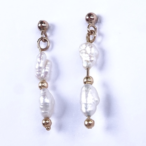 637 - A pair of late 20th century unmarked gold baroque pearl drop earrings, earring height excluding fitt... 