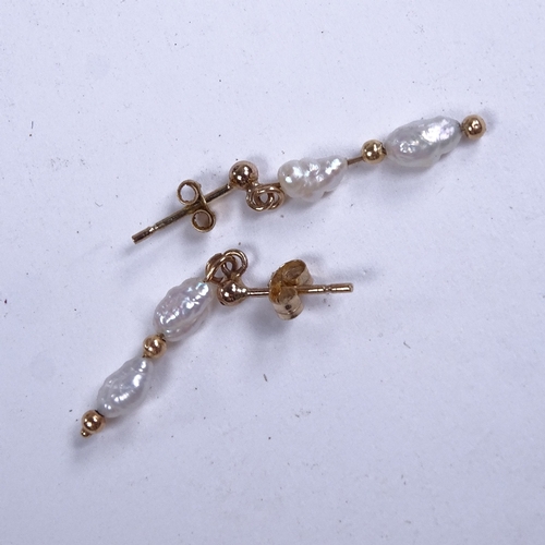 637 - A pair of late 20th century unmarked gold baroque pearl drop earrings, earring height excluding fitt... 