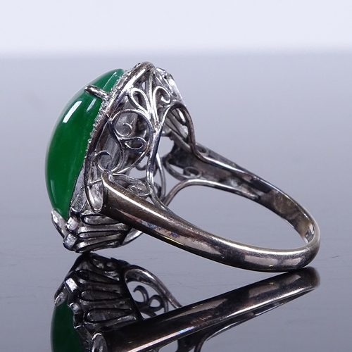 647 - An unmarked white gold cabochon jadeite and diamond cluster cocktail ring, jadeite measures: length ... 