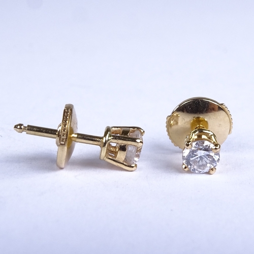 672 - DAVID MORRIS - a modern pair of 18ct gold solitaire diamond stud earrings, total diamond content app... 