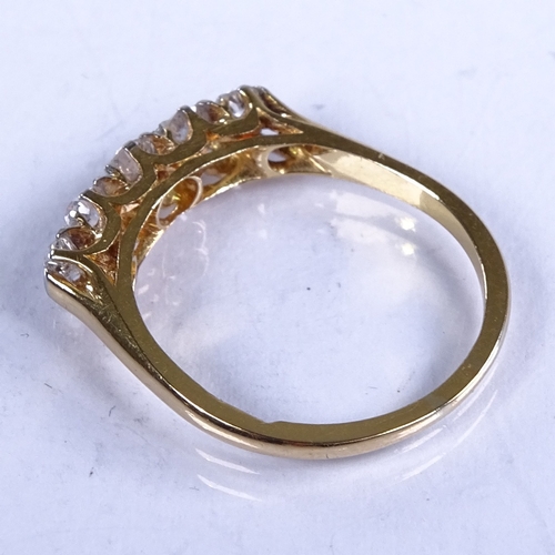 711 - An early 20th century 18ct gold graduated 5-stone diamond half hoop ring, total diamond content appr... 