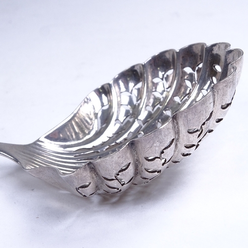 744 - A 19th century French silver sugar sifter spoon, pierced shell-shaped bowl with engraved lattice dec... 