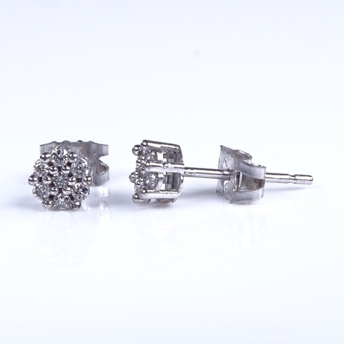 751 - A modern pair of 9ct white gold diamond cluster stud earrings, total diamond content approx 0.15ct, ... 