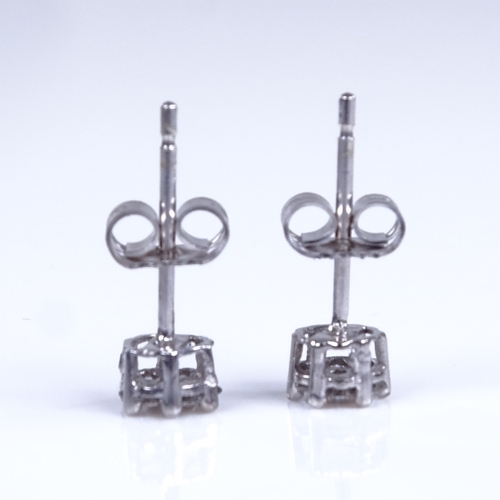 751 - A modern pair of 9ct white gold diamond cluster stud earrings, total diamond content approx 0.15ct, ... 