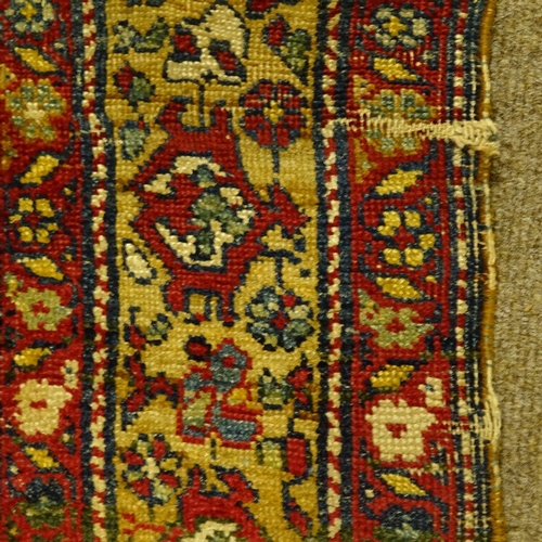 304 - A Persian handwoven geometric design rug