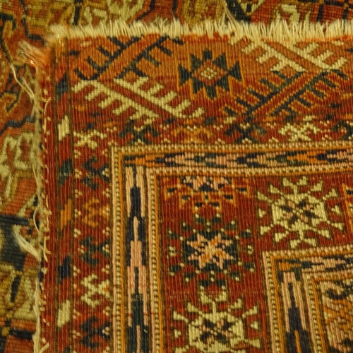 458 - A handmade Caucasian red ground geometric design rug