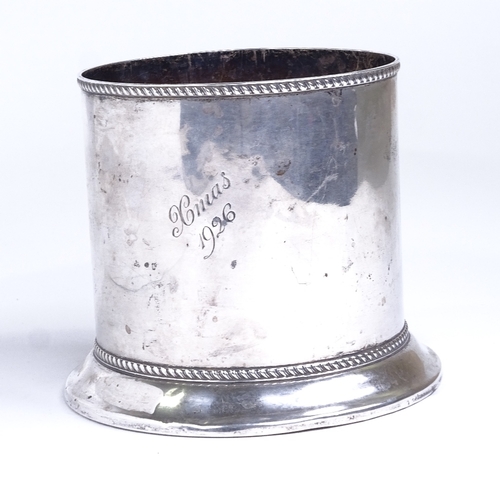 765 - An Edwardian silver cylindrical wine bottle coaster, turned oak base with gadrooned rim, by Barker B... 