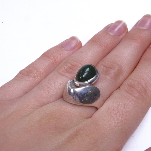 774 - A Vintage Scandinavian sterling silver cabochon green stone stylised ring, stamped Kaare, setting he... 