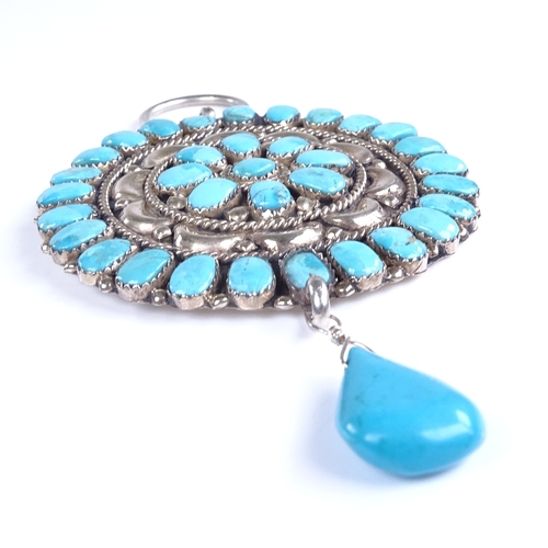 784 - A large Vintage turquoise and unmarked silver circular pendant, possibly Mexican, with pear-shaped t... 