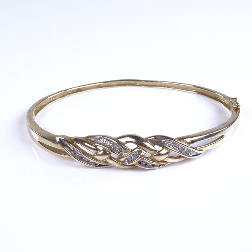 786 - A late 20th century unmarked gold diamond crossover hinged bangle, total diamond content approx 0.25... 