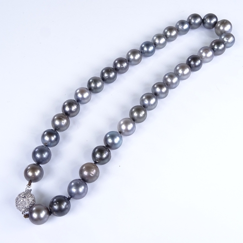 792 - A modern single-strand Princess length black pearl necklace, with 14ct white gold diamond set clasp,... 