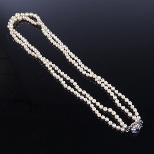 793 - A Vintage graduated double-strand Princess length cultured pearl necklace, on 9ct gold sapphire and ... 