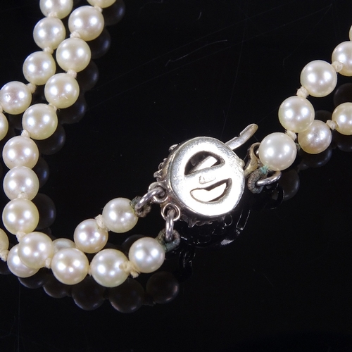 793 - A Vintage graduated double-strand Princess length cultured pearl necklace, on 9ct gold sapphire and ... 