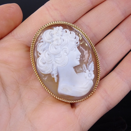 863 - A Vintage relief carved cameo shell panel brooch, depicting female profile, in 9ct gold rope twist f... 