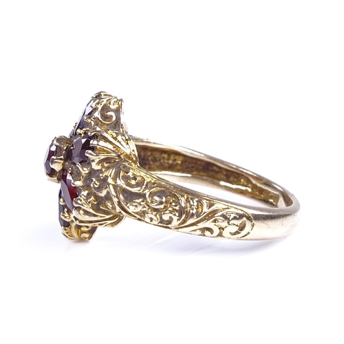 873 - A late 20th century 9ct gold garnet cluster flowerhead dress ring, setting height 14mm, size N, 4.2g