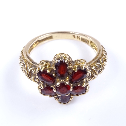 873 - A late 20th century 9ct gold garnet cluster flowerhead dress ring, setting height 14mm, size N, 4.2g