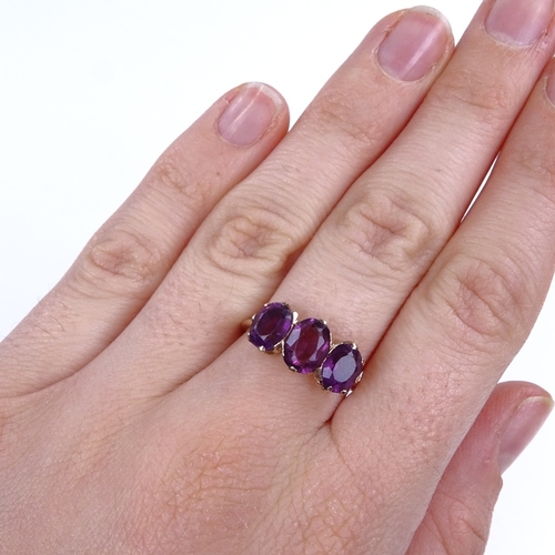 878 - An early 20th century 9ct gold 3-stone amethyst dress ring, setting height 8.6mm, size O, 2.4g