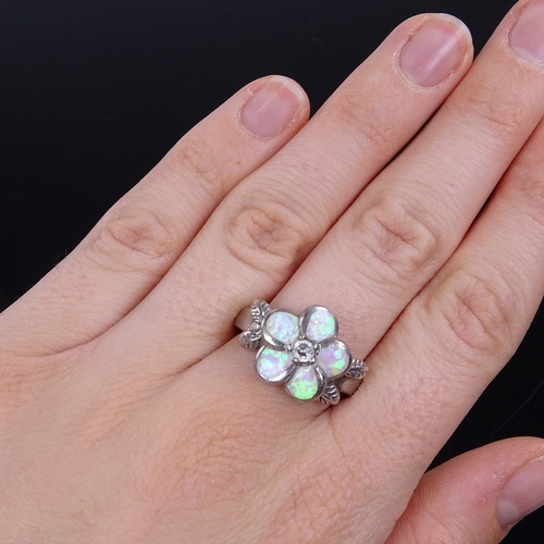 882 - A silver Gilson opal and white sapphire floral ring, and a similar silver opal and stone set dragonf... 