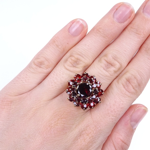 887 - A late 20th century 9ct gold garnet cluster flowerhead cocktail ring, setting height 21.7mm, size R,... 