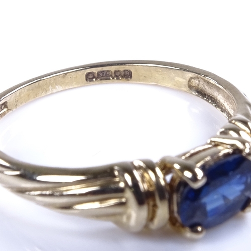 896 - A modern 9ct gold oval-cut sapphire dress ring, setting height 5.3mm, size M, 1.9g