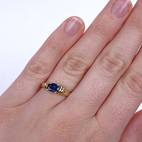 896 - A modern 9ct gold oval-cut sapphire dress ring, setting height 5.3mm, size M, 1.9g