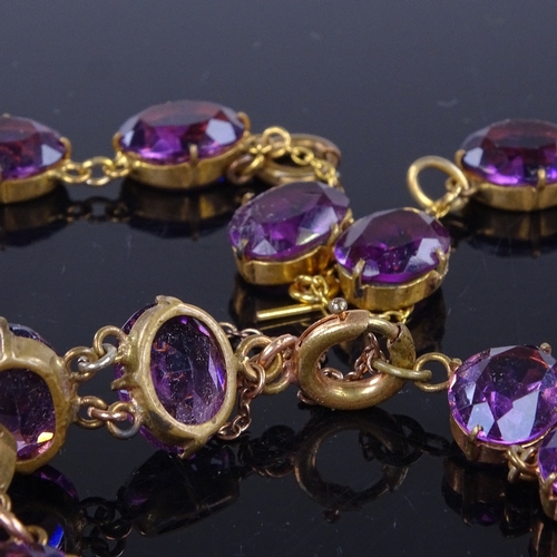 937 - A Vintage gilt-metal and amethyst Riviere demi parure, comprising necklace, bracelet and pair of cli... 