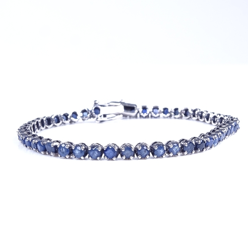 813 - A modern sterling silver sapphire tennis line bracelet, bracelet length 19cm, 10.4g