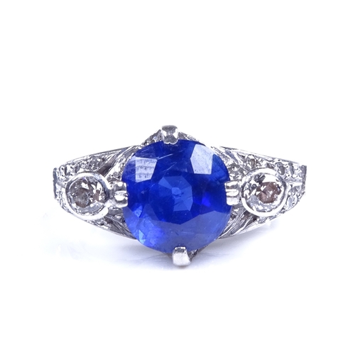 825 - A late 20th century palladium sapphire and diamond cluster dress ring, sapphire measures: length - 8... 