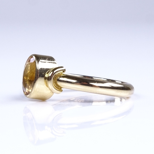 837 - A modern 18ct gold oval citrine dress ring, setting height 9.6mm, size O, 5.8g