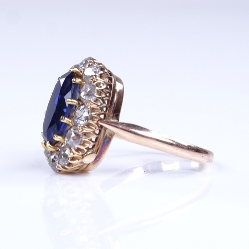 848 - A late 20th century unmarked high carat gold synthetic sapphire and diamond cluster ring, total diam... 