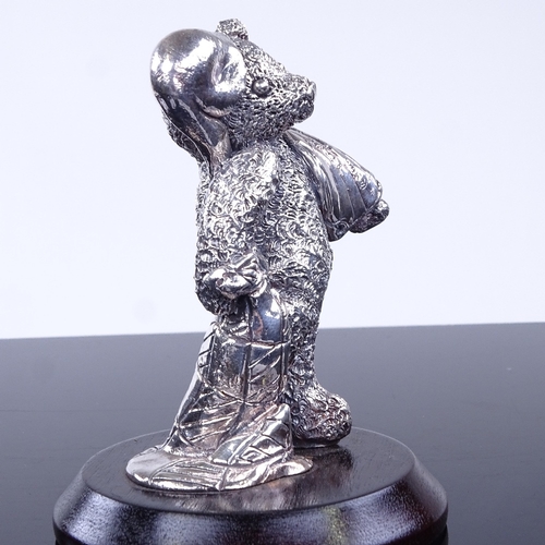 968 - A modern novelty silver-clad teddy bear figurine on wood stand, overall height 9.5cm