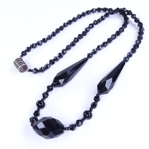 970 - A Vintage faceted jet necklace with unmarked silver clasp, necklace length 60cm, 35.9g