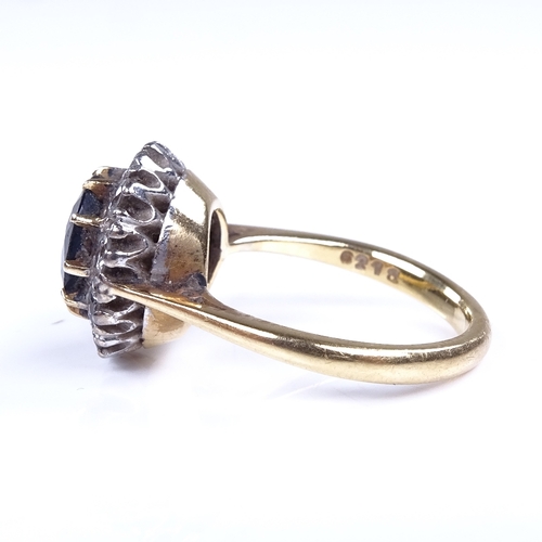 976 - A late 20th century unmarked high carat gold sapphire and diamond cluster ring, setting diameter 13.... 