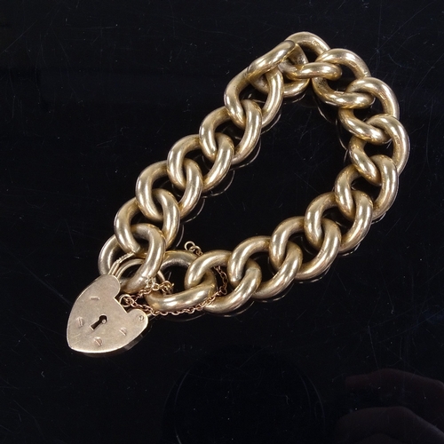 981 - A late 20th century solid 9ct gold curb link heart-padlock charm bracelet, bracelet length 16cm, 108... 