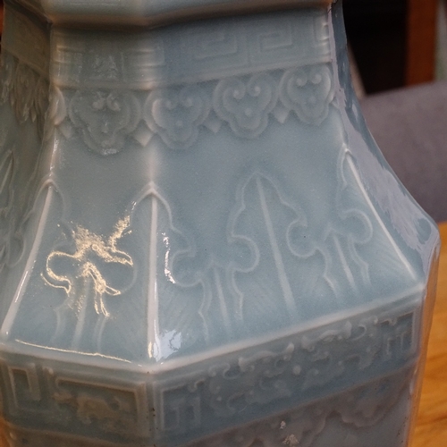 54 - A Chinese blue glaze celadon porcelain square-section vase, with canted corners and relief moulded d... 